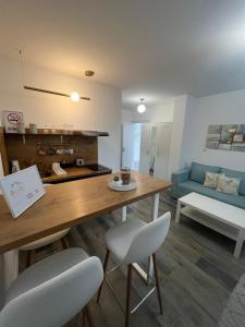 a kitchen and living room with a table and chairs at BeoAir apartments in Surčin