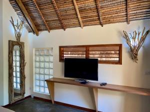 a flat screen tv sitting on a table in a room at La perle rare de Nosy be in Ambatoloaka