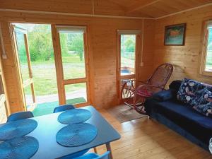 a living room with a couch and a table at Domek nad Olszanka in Olszanica