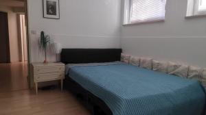 a small bedroom with a bed and a night stand at Lamonte in Munich