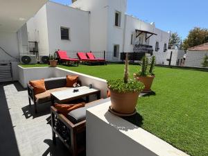 a backyard with a patio with a lawn at Loca Centre Suites in Bodrum City