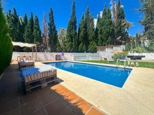 a swimming pool in a yard with trees at GARDEN HOUSE Malaga City in Málaga