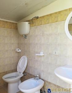a bathroom with a toilet and a sink at AUGUSTY - Fondi Vertice Houses in Lido Di Fondi +19 photos