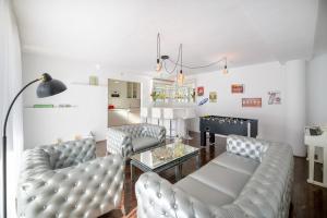 een woonkamer met twee banken en een tafel bij Spacious Private Villa up to 16 - Authentic Yaiza - Volcano, Timanfaya park, Bodega & South Beaches - Heated Pool - Game Room - Charcoal grill in Yaiza