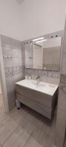 a bathroom with a sink and a mirror at Calliope in Terracina