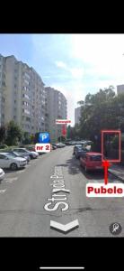 a street with cars parked on the side of the road at Lady Suite in Cluj-Napoca
