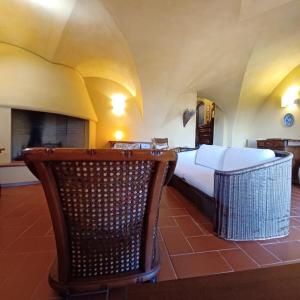a bedroom with a bed and a chair in a room at Dolce Vita- x8 Luxury Garda Lake in Gardone Riviera