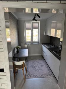 a small kitchen with a table and a chair at Lux house in Bălţi