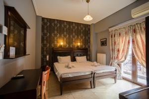 a bedroom with a bed and a window at Toti Boutique Rooms in Kalabaka