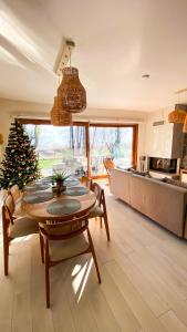 a living room with a table and a christmas tree at Shore of Sapanca Lake Çatı Villa Lakehouse in Kartepe