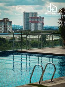 a swimming pool with a view of a city at JettBros De' milota at Midas Seri Alam Johor Bahru in Masai