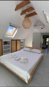 a large bedroom with a large bed with white sheets at Shore of Sapanca Lake Çatı Villa Lakehouse in Kartepe +94 photos