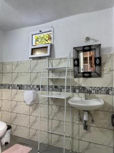 a bathroom with a sink and a mirror at Yousurf Surf House in Essaouira +90 photos