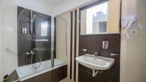 a bathroom with a sink and a shower at Toti Boutique Rooms in Kalabaka