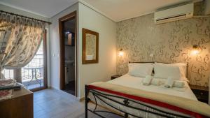 a bedroom with a bed with two teddy bears on it at Toti Boutique Rooms in Kalabaka