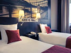 Łóżko lub łóżka w pokoju w obiekcie Mercure Wrocław Centrum