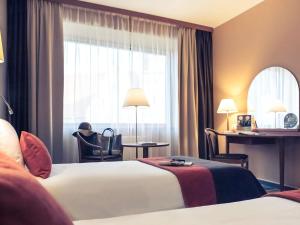 Łóżko lub łóżka w pokoju w obiekcie Mercure Wrocław Centrum