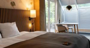 A bed or beds in a room at Hotel Dalgas, BW Signature Collection