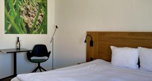 A bed or beds in a room at Hotel Dalgas, BW Signature Collection