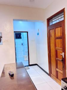 a room with a toilet and a wooden door at Mima homes in Gatunga