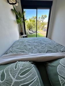 a bed in a room with a window at VILLA FENG SHUI déco bali St Aygulf 3 chambres in Saint-Aygulf +42 photos