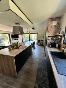 a kitchen with a large island in a room at VILLA FENG SHUI déco bali St Aygulf 3 chambres in Saint-Aygulf