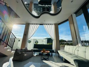 a living room with a couch and a table at Sele House in Hà Tiên