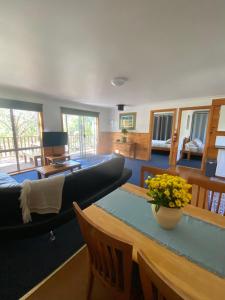 a living room with a couch and a table at Clifton Beach Lodge in Princetown