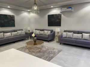 a living room with couches and a table at فلل بندورا in Khamis Mushayt