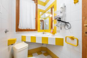a bathroom with a sink and a toilet and a mirror at Casa Leo in Calasetta +12 photos