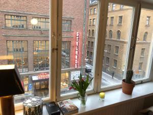 a window with a view of a street and buildings at Apartment in So-Fo at Södermalm 24sqm in Stockholm