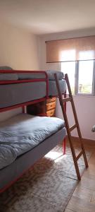 a bedroom with two bunk beds and a window at Las Vistas Apartament in La Rambla +12 photos