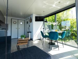 a kitchen and dining room with a table and chairs at Houseboat Heeg on the Water | 4 people in Heeg