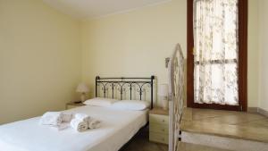 Un dormitorio con dos camas con toallas encima. en Welcomely - La Porta Sul Mare, en Golfo Aranci