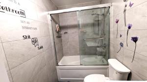 a bathroom with a shower and a toilet at The Downtown Gem Toronto in Toronto