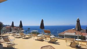 a group of chairs and umbrellas on a patio at Hotel La Meridiana in Sorrento