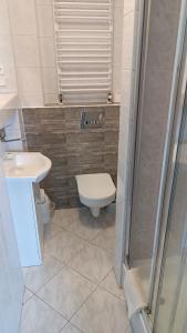 a bathroom with a toilet and a sink and a shower at DW FALA in Rewal +26 photos