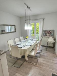 a dining room with a table with white chairs and a dining room at Kameni Dvori in Imotski