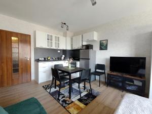 a kitchen and dining room with a table and chairs at Studio Jade in Varna City