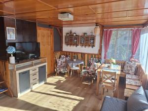 a living room with a kitchen and a dining room at Chata u tří borovic in Chvalatice