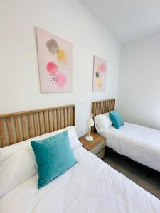 2 Betten in einem weiß-blauen Zimmer in der Unterkunft Beleef Spanje new luxury apartment with sea view in Orihuela + 31 Fotos