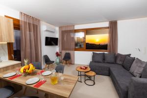 a living room with a couch and a table at Olivia in Pigianos Kampos