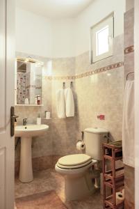 a bathroom with a toilet and a sink at Manolia house near beach, near airport in Aghia Marina +20 photos