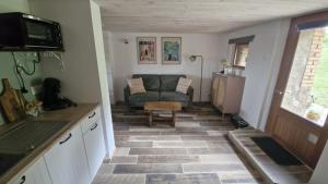a living room with a couch and a table at La Maison Rose in Bertignat