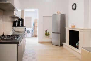 a kitchen with a stove and a refrigerator at Dimora Mamma Lena in Carovigno