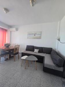a living room with a couch and a table at Beach view apartment in Cullera in Cullera