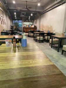 a dining room with wooden floors and tables and chairs at Yellow door Hua Hin in Hua Hin