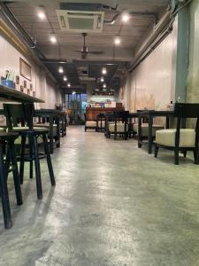 an empty room with tables and chairs in it at Yellow door Hua Hin in Hua Hin