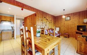 a kitchen and dining room with a wooden table and chairs at Gorgeous Apartment In Gérardmer With Wifi in Gérardmer