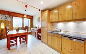 a kitchen with wooden cabinets and a wooden table at Gorgeous Apartment In Gérardmer With Wifi in Gérardmer